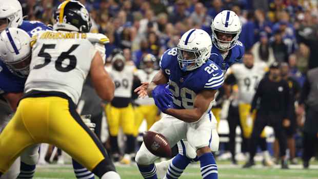 Nov 28, 2022; Indianapolis, Indiana, USA; Indianapolis Colts quarterback Matt Ryan (2) fumbles the ball on the handoff to running back Jonathan Taylor (28) during the second half against the Pittsburgh Steelers at Lucas Oil Stadium.